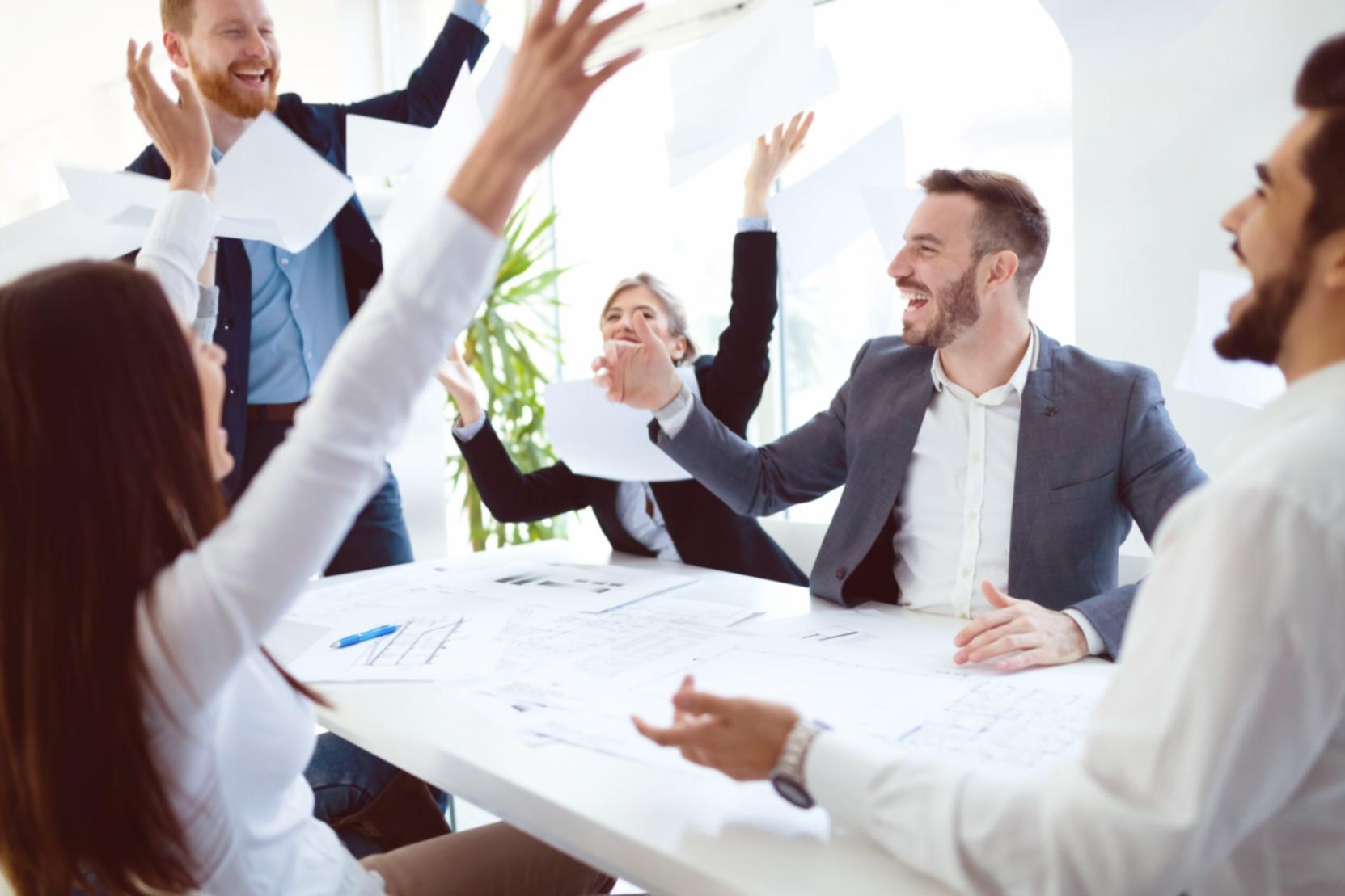 Team collaboration session reviewing analytics dashboard and discussing optimization strategies